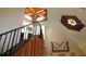 Interior view of staircase with wood railing and vaulted ceilings at 2512 Ayers Hill Ct, Lutz, FL 33559