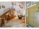 Inviting entryway with tiled floor, wooden staircase, and views into the living room at 2512 Ayers Hill Ct, Lutz, FL 33559