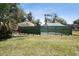 Screened-in pool with surrounding grassy area at 2512 Ayers Hill Ct, Lutz, FL 33559
