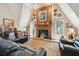 Living room with fireplace, leather sofas, and large windows at 2512 Ayers Hill Ct, Lutz, FL 33559