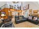 Open living room with leather furniture, high ceilings, and views to the kitchen and dining areas at 2512 Ayers Hill Ct, Lutz, FL 33559