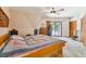 Spacious bedroom with a wooden platform bed and access to a patio at 2512 Ayers Hill Ct, Lutz, FL 33559