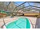 Inviting kidney-shaped pool with screened enclosure at 2512 Ayers Hill Ct, Lutz, FL 33559