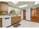 Galley kitchen with wood cabinets, tile floors, and updated appliances at 2512 Ayers Hill Ct, Lutz, FL 33559