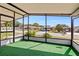 Relaxing screened porch with artificial turf flooring and views of the community at 3931 Chris Dr, Wesley Chapel, FL 33543