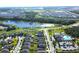 Aerial view of a residential community with ponds, roads, and amenities at 17035 Peaceful Valley Dr, Wimauma, FL 33598