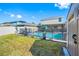 View of the backyard with a pool surrounded by a safety fence at 17035 Peaceful Valley Dr, Wimauma, FL 33598