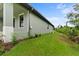 House side view, showcasing landscaping and a partially visible porch at 156 Haddock Dr, Rotonda West, FL 33947