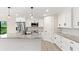 Modern kitchen with white cabinets, granite countertops and island at 156 Haddock Dr, Rotonda West, FL 33947