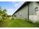 Side view of house showcasing landscaping and garage at 156 Haddock Dr, Rotonda West, FL 33947