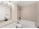 Clean bathroom with a bathtub, vanity, and tile surround at 156 Haddock Dr, Rotonda West, FL 33947