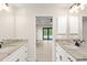 Double vanity bathroom with granite countertop and access to bedroom at 156 Haddock Dr, Rotonda West, FL 33947