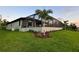 Newly built home with a well-manicured lawn at 156 Haddock Dr, Rotonda West, FL 33947