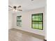 Bedroom with wood-look floors and two large windows at 156 Haddock Dr, Rotonda West, FL 33947