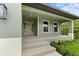 Inviting front porch with beige door and steps leading to the entrance at 156 Haddock Dr, Rotonda West, FL 33947