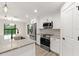 Modern kitchen with white cabinets, granite countertops, and stainless steel appliances at 156 Haddock Dr, Rotonda West, FL 33947