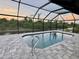 Inviting pool area with screened enclosure at 156 Haddock Dr, Rotonda West, FL 33947