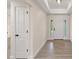 Bright entryway with neutral walls, wood-look floors, and white doors at 156 Haddock Dr, Rotonda West, FL 33947