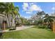 Expansive backyard with artificial turf, basketball hoop, pool, deck, and privacy fence at 5002 W Homer Ave, Tampa, FL 33629