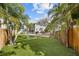 Spacious backyard with artificial grass, a soccer goal, a pool, and tall, mature trees for privacy at 5002 W Homer Ave, Tampa, FL 33629