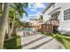 Beautiful backyard featuring a pool, deck, lounge chairs, and lush landscaping at 5002 W Homer Ave, Tampa, FL 33629