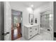 Bright white bathroom featuring white cabinets, a framed mirror, and a separate tub/shower at 5002 W Homer Ave, Tampa, FL 33629