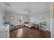 Spacious bedroom with dark hardwood floors, a ceiling fan, a large window, and neutral-colored decor at 5002 W Homer Ave, Tampa, FL 33629