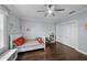 Neutral-toned bedroom features a bed with an upholstered headboard and a ceiling fan at 5002 W Homer Ave, Tampa, FL 33629