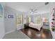 Inviting bedroom with light blue walls, wood floors, and a ceiling fan at 5002 W Homer Ave, Tampa, FL 33629