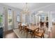 Spacious dining room with hardwood floors, a decorative chandelier, and large windows that let in natural light at 5002 W Homer Ave, Tampa, FL 33629
