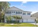 Charming two-story home featuring a welcoming balcony, a manicured lawn, and a convenient two-car garage at 5002 W Homer Ave, Tampa, FL 33629