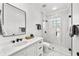 Modern bathroom with white vanity, frameless shower, and marble flooring at 5002 W Homer Ave, Tampa, FL 33629