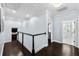 Bright upstairs hallway with dark wood floors, white trim, and views into the bathroom and sitting area at 5002 W Homer Ave, Tampa, FL 33629