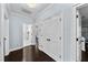 Hallway featuring hardwood floors, neutral walls, white trim, and access to bedrooms and bathrooms at 5002 W Homer Ave, Tampa, FL 33629