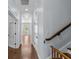 Hallway with hardwood floors and white trim, leading to another room, creating a bright and inviting space at 5002 W Homer Ave, Tampa, FL 33629