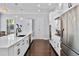 Modern kitchen featuring a large center island, white cabinets, stainless steel appliances and stylish lighting at 5002 W Homer Ave, Tampa, FL 33629