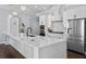 Modern kitchen featuring a large center island, white cabinets, stainless steel appliances and stylish lighting at 5002 W Homer Ave, Tampa, FL 33629