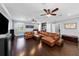 Spacious living room featuring a large sofa, a modern entertainment center, a bar and wood floors at 5002 W Homer Ave, Tampa, FL 33629