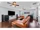 Spacious living room featuring a large sofa, a modern entertainment center, a bar and wood floors at 5002 W Homer Ave, Tampa, FL 33629
