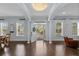Spacious and bright living room with high ceilings, large windows, hardwood floors, and an elegant chandelier at 5002 W Homer Ave, Tampa, FL 33629
