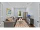 Living room featuring a comfortable sofa, neutral walls, wood floors, and a stylish rug at 5002 W Homer Ave, Tampa, FL 33629