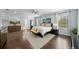 Spacious primary bedroom featuring hardwood floors, ample natural light, ceiling fan, and a glimpse of an en-suite bathroom at 5002 W Homer Ave, Tampa, FL 33629