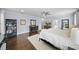 Bright primary bedroom with hardwood floors, neutral walls, ceiling fan, and a view into an en-suite bathroom at 5002 W Homer Ave, Tampa, FL 33629