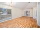 Living room with laminate floors, large windows, and chandelier at 11440 Misty Isle Ln, Riverview, FL 33579