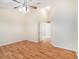 Large bedroom with laminate flooring, ceiling fan, and en-suite bathroom access at 11440 Misty Isle Ln, Riverview, FL 33579
