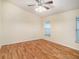 Bright bedroom with laminate wood flooring and ceiling fan at 11440 Misty Isle Ln, Riverview, FL 33579