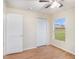 Well-lit bedroom with laminate flooring, ceiling fan and a window with a view at 11440 Misty Isle Ln, Riverview, FL 33579