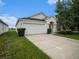 Single-story house with attached garage and manicured lawn at 11440 Misty Isle Ln, Riverview, FL 33579