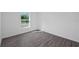 Bright bedroom with gray vinyl plank flooring and a window at 12461 Patsy Ave, Port Charlotte, FL 33981