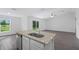Kitchen island with granite countertop and stainless steel sink at 12461 Patsy Ave, Port Charlotte, FL 33981